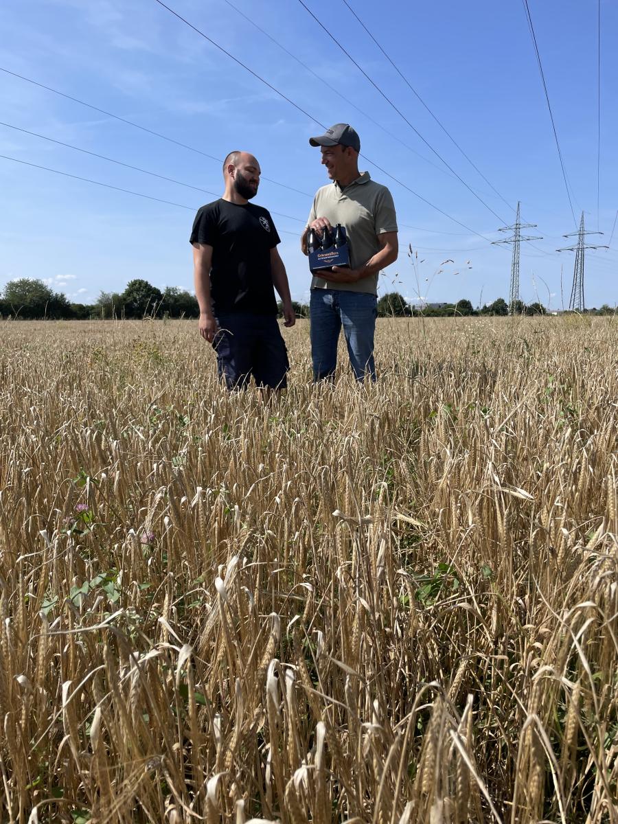 Menschen sitzen im Braugerstenfeld