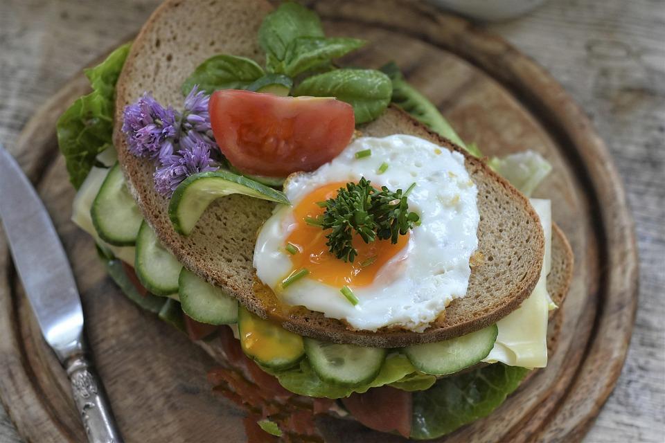 Belegtes Brot mit Käse, Ei, Gurken, Tomaten, Kräuter