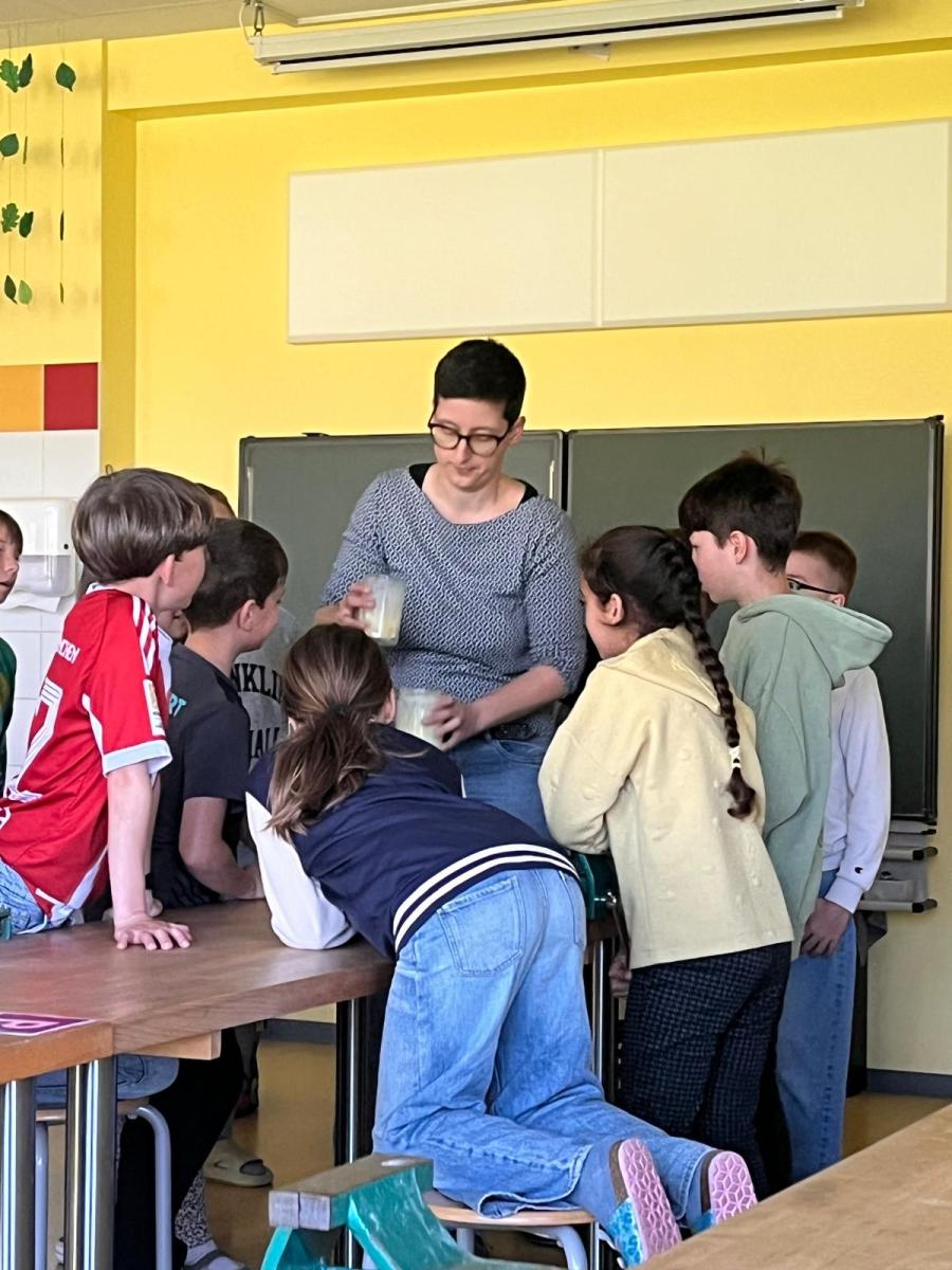 Marina Eltschka zeigt den Grundschülern in Euerbach wie man Butter selbst herstellt